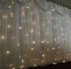 the curtains are covered with white lights