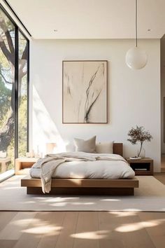 a large bed sitting inside of a bedroom on top of a hard wood floor