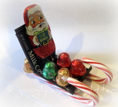 a santa clause sleigh with candy canes and candies on it's side