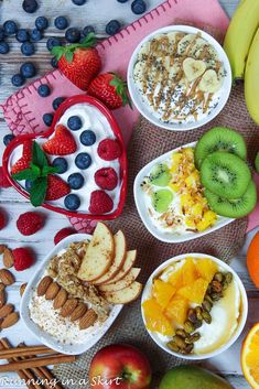 there are many different fruits and cereals in bowls on the table with strawberries