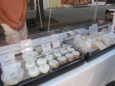 a display case filled with lots of different types of food on top of a table