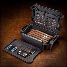 an open case with cigars in it on a wooden table