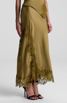 Tonal lace trim highlights the asymmetric silhouette of this smooth satin skirt. 35" length 100% viscose with 100% nylon contrast Dry clean Imported Skirts Trend 2024, Tailor Clothes, Silk Skirts, Satin Maxi Skirt, Tailored Clothes, Lace Midi Skirt, Latest Skirts, Skirt Trends, Lace Outfit