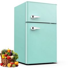 a blue refrigerator sitting next to a pile of fruit and vegetables on a white background