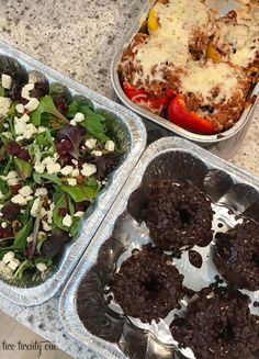 three trays filled with food sitting on top of a marble counter next to each other