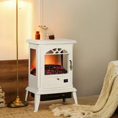 a white stove sitting in the corner of a room next to a rug and lamp