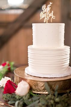 a white wedding cake sitting on top of a table