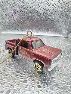 a red toy truck with a chain on it