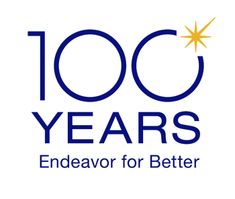 the words 100 years endeavor for better written in blue on a white background with an orange star