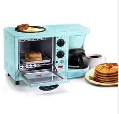 a blue toaster oven sitting next to a stack of pancakes