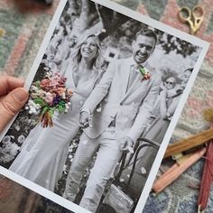 a man and woman are holding up a wedding photo