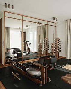 an exercise room with mirrors, machines and other equipment in it's center area