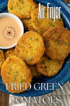 fried green tomatoes on a blue plate with dipping sauce in the middle and air fryer