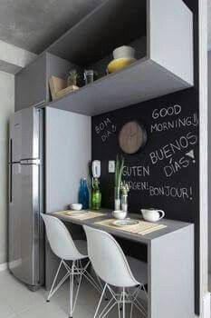 a small kitchen with a chalkboard on the wall