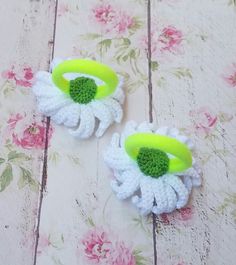 two crocheted flower hair clips with green centers