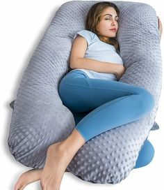 a woman laying on top of an inflatable pillow