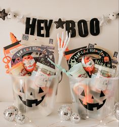 two plastic buckets filled with halloween items