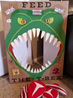 there is a cardboard box with a fake alligator's mouth in front of it