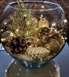 a glass bowl filled with ornaments and lights