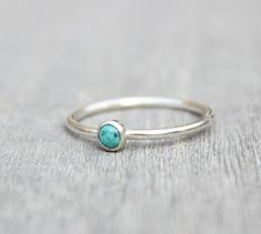 Beautiful December birthstone stacking ring. Made in .925 sterling silver and stone is a 3mm genuine turquoise. This ring is made to order in your size. If you don't see your size available please feel free to message me. All orders ship in a gift box. If you are ordering multiple items and want them boxed separately, please let me know in the notes at checkout. I ship via USPS. Please review the estimated delivery date and processing times. Processing times vary based on how busy my shop is at Turquoise Gemstone Stackable Rings In Sterling Silver, Stackable Sterling Silver Turquoise Ring, Minimalist Stackable Turquoise Ring For Anniversary, Luxury Stackable Turquoise Ring In Sterling Silver, Minimalist Adjustable Turquoise Ring For Everyday, Minimalist Turquoise Jewelry For Anniversary, Turquoise Minimalist Jewelry For Anniversary, Adjustable Sterling Silver Turquoise Birthstone Ring, Dainty Turquoise Stackable Ring