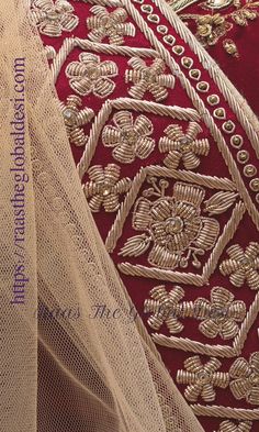 closeup of the back of a red dress with gold embroidered details and sheer fabric