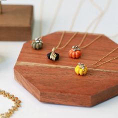 The cutest accessory you'll have this Fall 🎃 An adorable painted pumpkin necklace on delicate gold-filled chain that pairs perfectly with every sweater. Available in two lengths - 15" with a 2" extender or a longer 26" for bulky sweaters and layering. Availble in multiple colors, and either gold-filled or sterling-silver chain. Length: 15" with 2" extender OR 26" Pumpkin Colors: Black/Gold White/Gold Orange/Gold Orange/Silver Yellow/Silver Green/Silver Materials: Pumpkin - 14kt gold plated/ster Bulky Sweaters, Pumpkin Necklace, Silver Jewelry Accessories, Painted Pumpkin, Black Gold Chain, Witch Jewelry, Pumpkin Earrings, Pumpkin Colors, White Gold Chains