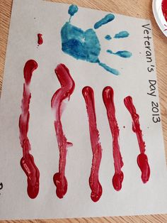 a child's handprint with red and blue paint