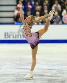 a female figure skating on an ice rink