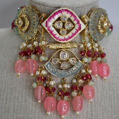 Introducing this intricate piece from our new meenakari collection. Handcrafted to perfection with Tyaani Kundan and meenakari design, This choker set is definitely a uniqueness in itself. The colors are so perfect for any upcoming events. A perfect combination of bubblegum pink, ruby and mint mini pearls and gold. Such a beauty!! ALL SALES ARE FINAL!! KINDLY MESSAGE ME IF YOU HAVE ANY QUESTIONS. Intricate Kundan Choker For Festivals, Zari Work Choker For Festivals And Gifts, Festival Kundan Choker With Intricate Design, Kundan Choker With Intricate Design For Festivals, Festive Zari Work Choker As Gift, Diwali Gift Zari Work Choker, Kundan Choker With Zari Work For Gift, Gift Kundan Choker With Zari Work, Festival Choker With Zari Work For Gift