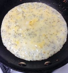 an omelet is being cooked in a skillet on the stove with oil