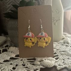 a pair of earrings with pokemon characters on them