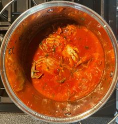 a large pot filled with lots of food on top of a stove burner oven