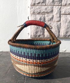 a woven basket sitting on top of a stone floor