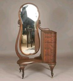 an antique dressing table with a mirror on it