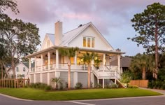 a large white house sitting on the side of a road