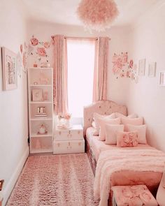 a bedroom with pink decor and flowers on the walls, bedding and dressers