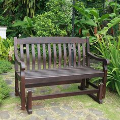 a wooden bench sitting in the middle of a garden