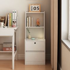 a white book shelf with books on it next to a desk and window sill