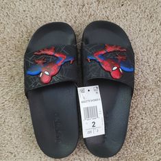 Adidas Spiderman Shower Slides. Synthetic Upper And Ethylene Vinyl Acetate Sole. Synthetic Low-top Non-slip Slides, Non-slip Low-top Synthetic Slides, Non-slip Synthetic Low-top Slides, Adidas Slip-on Slides, Adidas Non-slip Flat Slides, Adidas Non-slip Black Slides, Adidas Non-slip Slides With Round Toe, Adidas Non-slip Slides For Streetwear, Adidas Logo Sporty Slip-on Slides