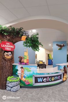 the children's play area is decorated with animals, trees and welcome signs for their school