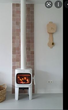 a white stove sitting next to a brick wall