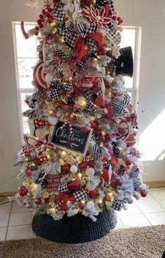 a christmas tree decorated with red, white and black bows