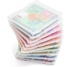 a stack of plastic containers filled with lots of different colored papers on top of each other