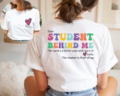 a woman wearing a t - shirt that says student behind me