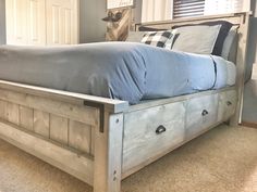 a bed sitting in the middle of a bedroom next to a window