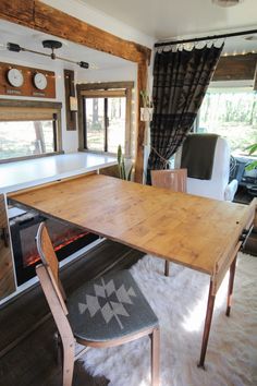 a wooden table sitting in front of a fire place