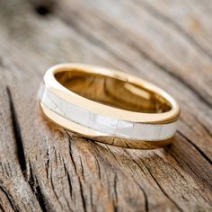 a wedding ring sitting on top of a wooden table