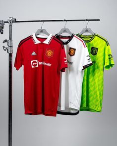 three soccer jerseys hanging on a clothes rack