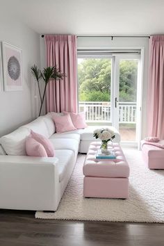 a living room filled with white furniture and pink curtains