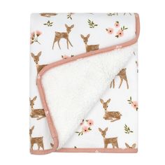 a white blanket with deers and flowers on it, in front of a white background